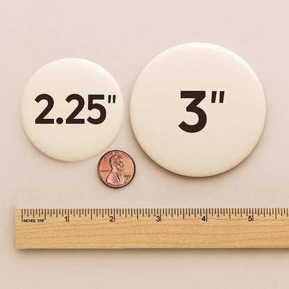 a ruler and two circular objects, one labeled "2.25" and the other labeled "3", along with a penny for scale.
