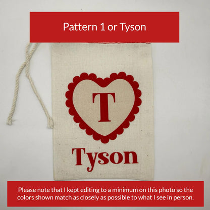 a beige canvas bag with a red heart-shaped logo and the name "Tyson" printed on it.