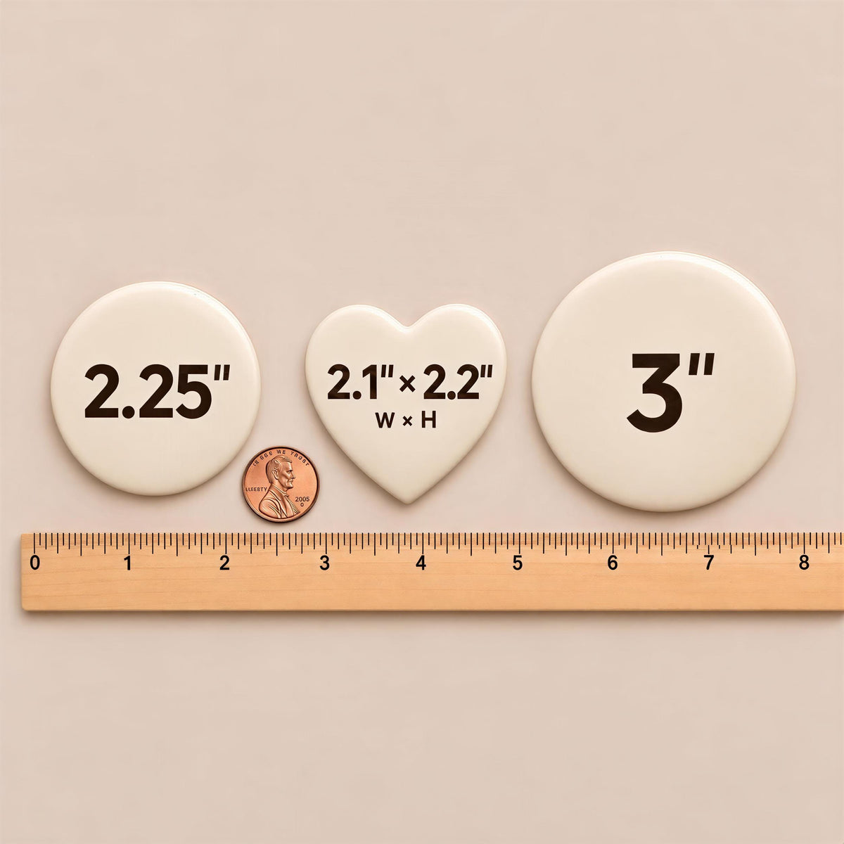 three white buttons with black text and numbers, and a small copper coin for scale.