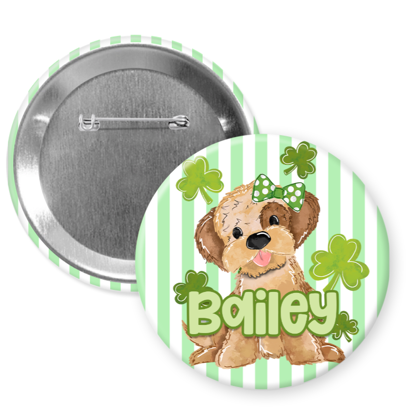 A round pin with a cartoon dog and shamrocks, along with the name "Biley" written on it.