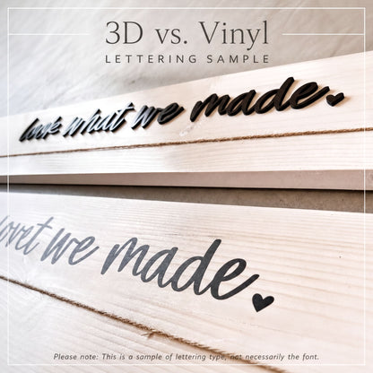 two close-up views of a wooden surface with text engraved on it. The text reads "look what we made" and "but we made." The text is in a cursive font, and there is a small heart symbol between the words "look" and "what." The image is a sample of lettering type, not necessarily the font used in the actual design.