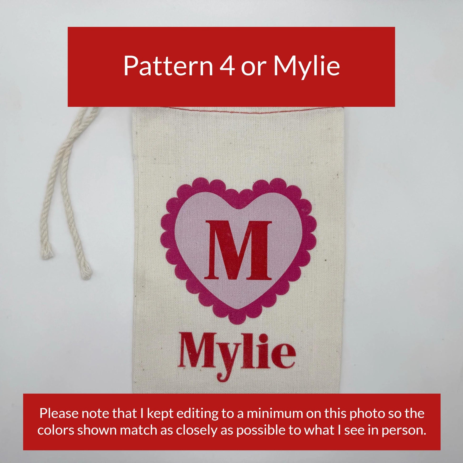 a white fabric with a pink heart-shaped logo and the name "Mylie" printed on it.