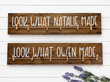 two wooden boards with the phrase "Look What Natalie Made" written on them, with clothespins attached to the boards.