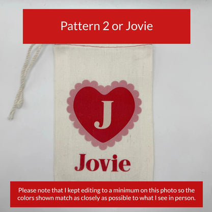 A white canvas bag with a red heart-shaped logo and the word "Jovie" printed on it.