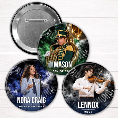 Custom music photo buttons featuring a marching band member, a vocalist, and a violinist with personalized names and years, shown with the pinback on a white wood background