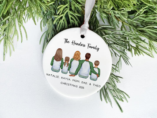 A white ornament with a family tree design, featuring four people sitting together.