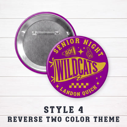 a purple and gold pin with the text "SENIOR NIGHT WILDCATS LANDON QUICH" printed on it. The pin is placed on a white wooden surface, and there is a description below the pin stating "STYLE 4 REVERSE TWO COLOR THEME".