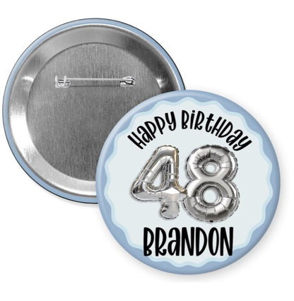A birthday button with the number 48 and the name 'Brandon' printed on it.